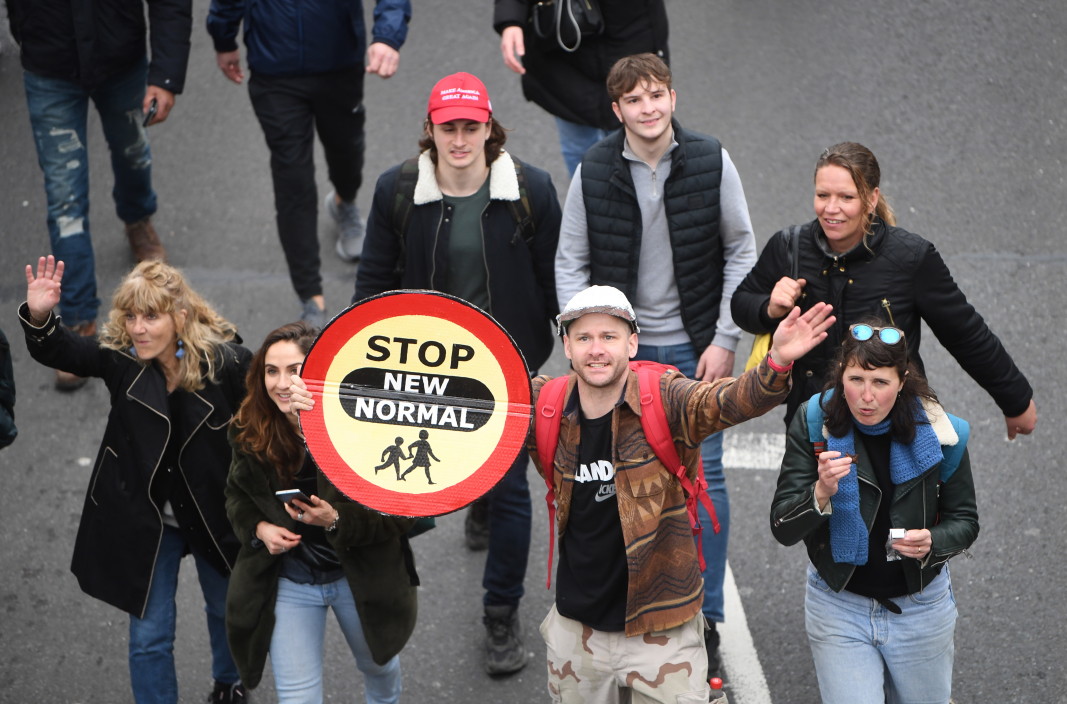  Протестиращи младежи в Лондон издигат знак с надпис „ Спрeте новото обикновено “ - 20 март 2021 година 