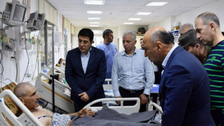 Сирийският министър на здравеопазването Хасан ал-Габаш (вляво) на посещение на ранен при атаката с дрон 
 срещу сирийската военна академия в Хомс, Сирия, 5 октомври 2023 г.