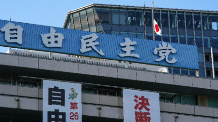 Японският флаг е свален наполовина в знак на траур над щабквартирата на Либерално-демократическата партия на Япония, 9 юли 2022 г.
