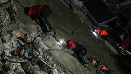 Rescue teams search for survivors in the rubble of a destroyed apartment building in the city of Iskenderun, February 6, 2023.