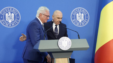 Главният изпълнителен директор на Rheinmetall AG Армин Папергер (вляво) и румънският министър-председател Илие Боложан (вдясно) в края на пресконференция в централата на правителството в Букурещ, 3 ноември 2025 г.