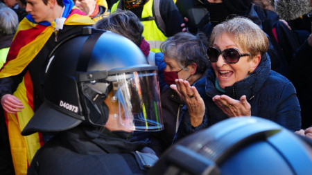 Жена спори с полицай за борба с безредиците по време на митинг, свикан от Комитетите за защита на републиката (CDR)  по време на испанско-френската среща на върха в Барселона, 19 януари 2023 г.