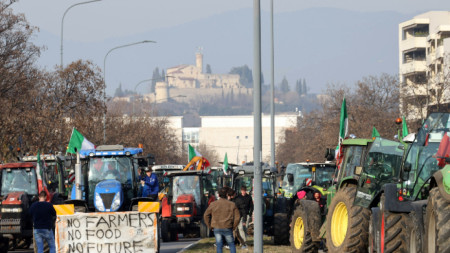 Италианските фермери протестират с тракторите си, като са поставили транспарант: 