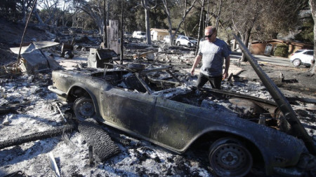 Британецът Дейвид Спенс гледа изгорялата си ретро спортна кола в Уестлей вилидж, Калифорния. Пожарите в US щата погубиха десетки, унищожиха стотици домове и изпепелиха над 120 000 хектара.