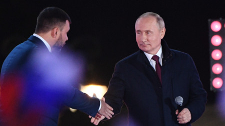 Руският президент Владимир Путин (вдясно) се ръкува с главата на ДНР Денис Пушилин на концерта след церемонията за подписване на договори за присъединяване на нови територии към Русия на Червения площад, Москва, 30 септември 2022 г. 