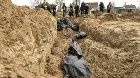Тела на цивилни в найлонови чували в масов гроб в Буча, 4 април 2022 г.