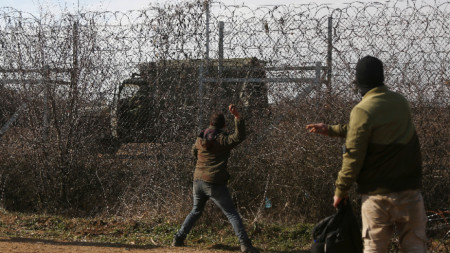 Мигранти хвърлят камъни по гръцки военен автомобил на границата.