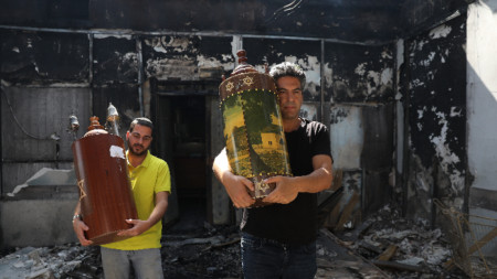 Жители на Лод напускат опожарена синагога.
