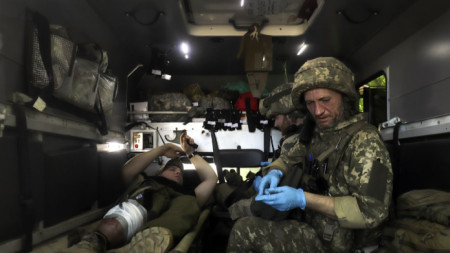 Военен медик оказва първа помощ на украински военен край Свитлодарск, Донецка област, 10 юни 2022 г. 