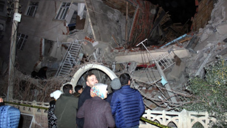 Хора пред разрушена сграда след силно земетресение в провинция Елязъг, Турция
