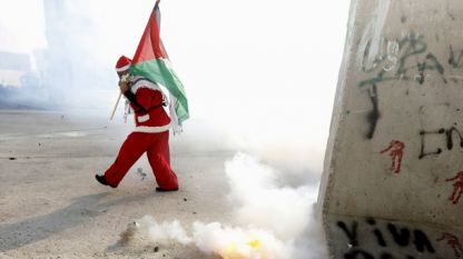 Протестиращ палестинец, облечен като Дядо Коледа във Витлеем